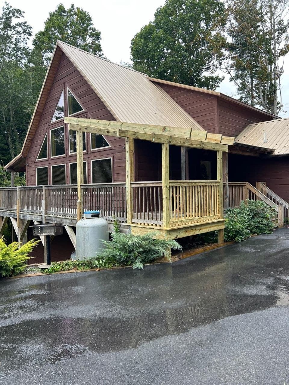 Porch pergola addition being built on an A-frame cabin