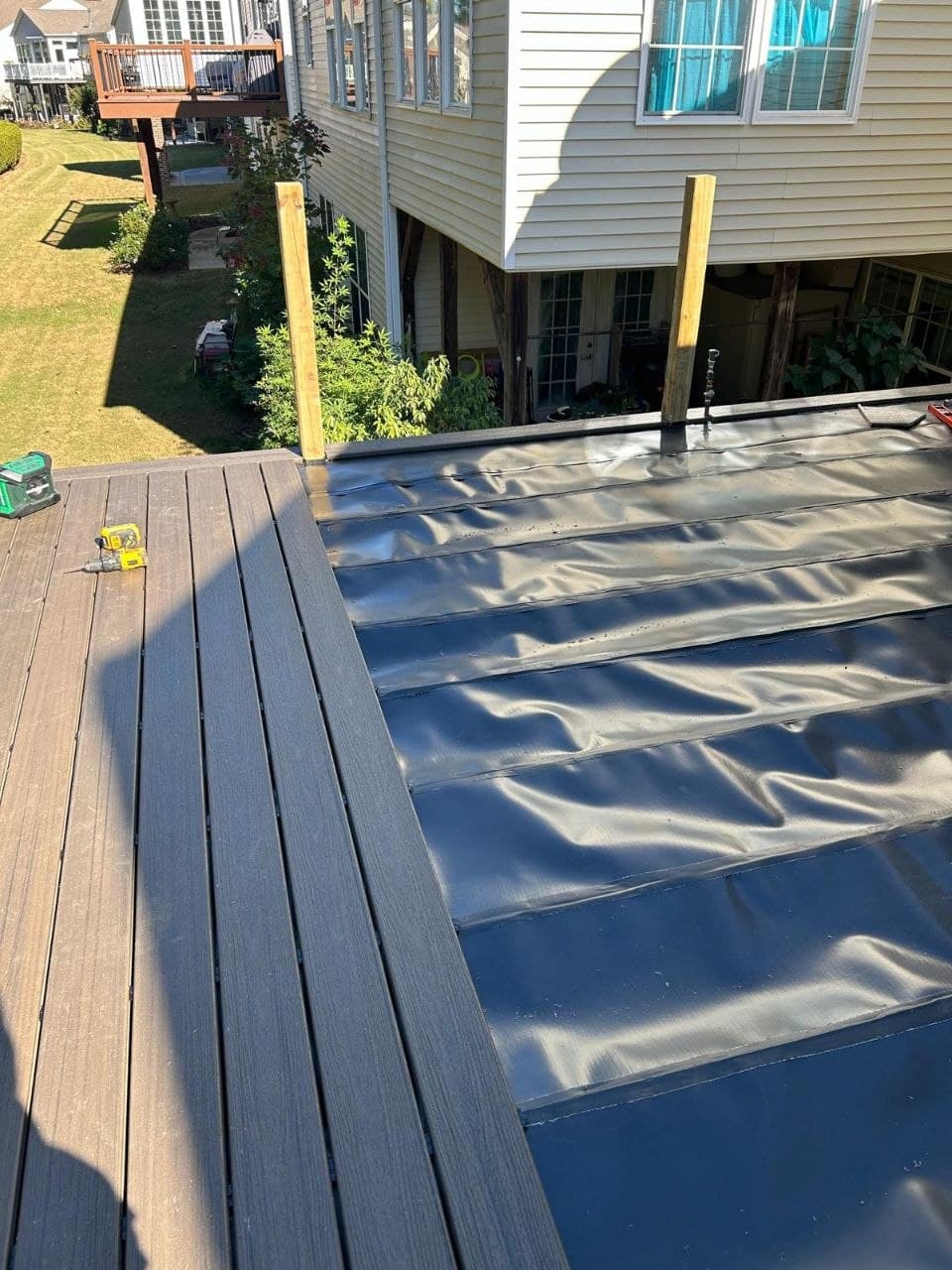 Waterproofed deck surface over covered patio