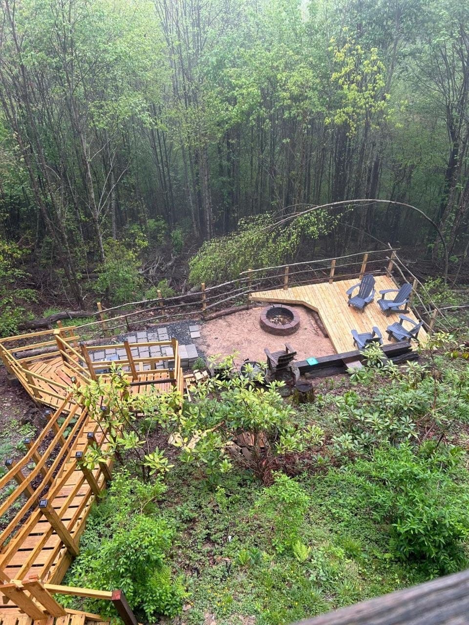 Hillside fire-pit deck with Adirondack chairs and connecting walkway