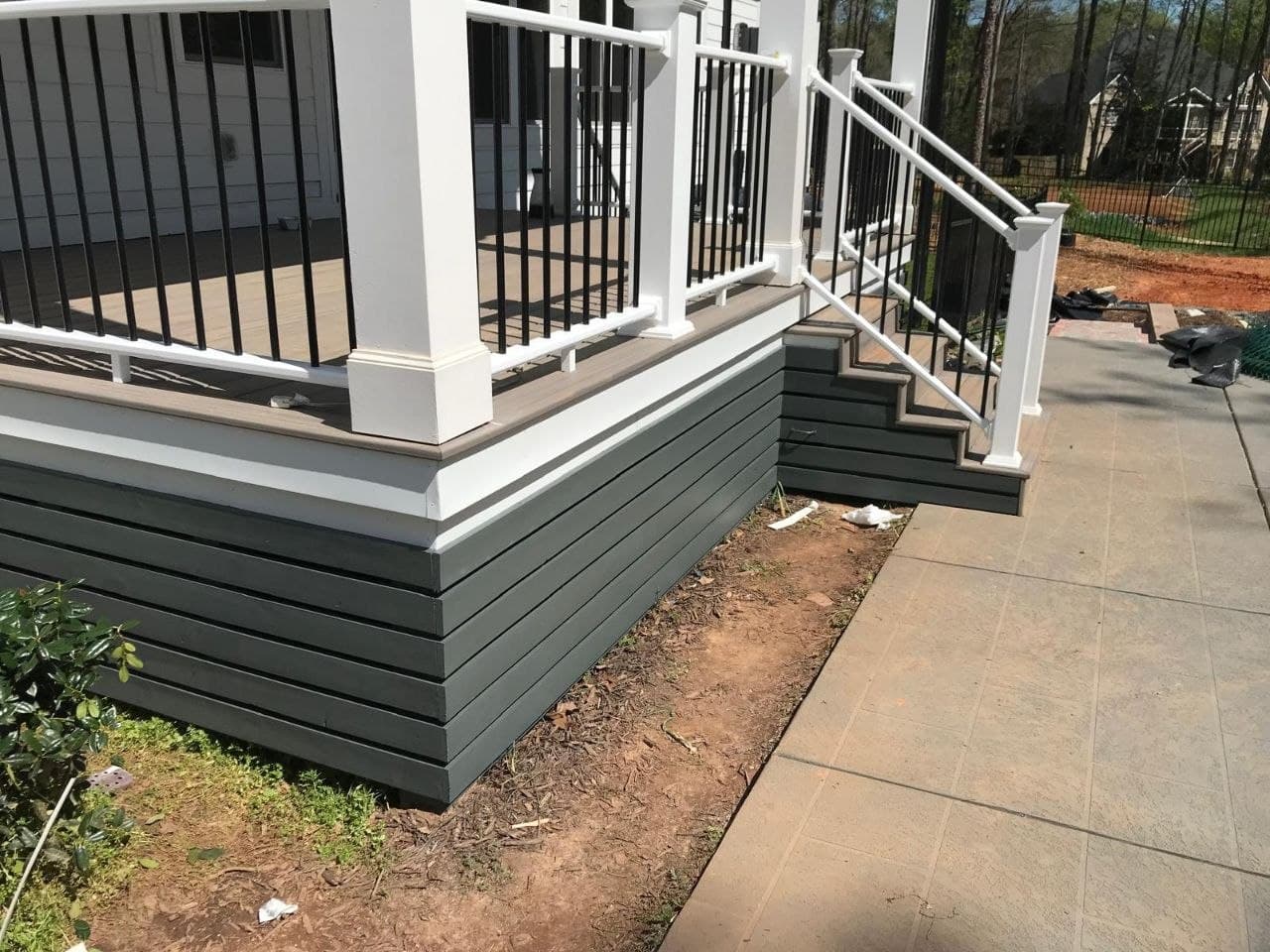 Gray composite deck with white posts and black balusters