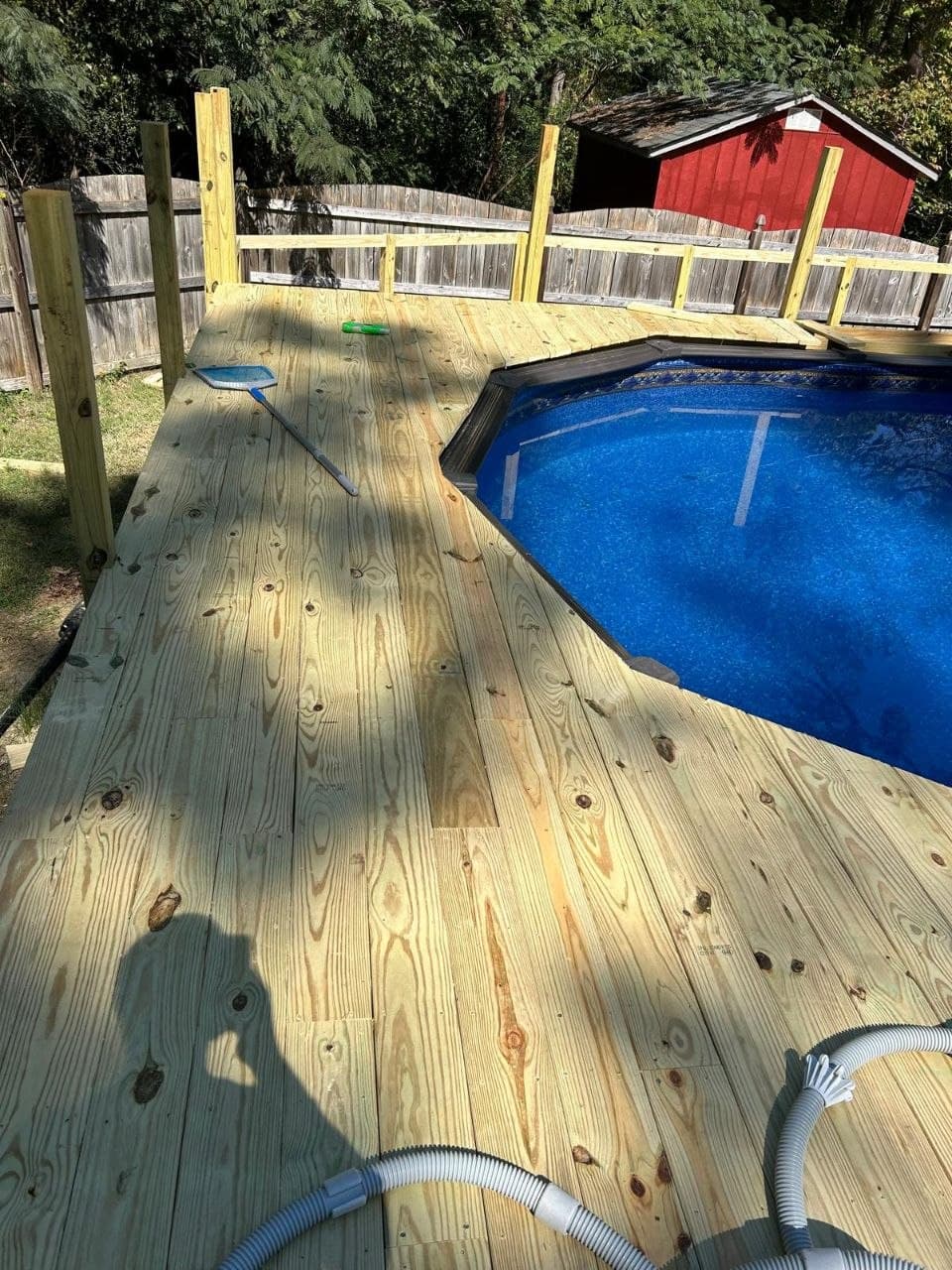 Wooden deck built around an above-ground pool