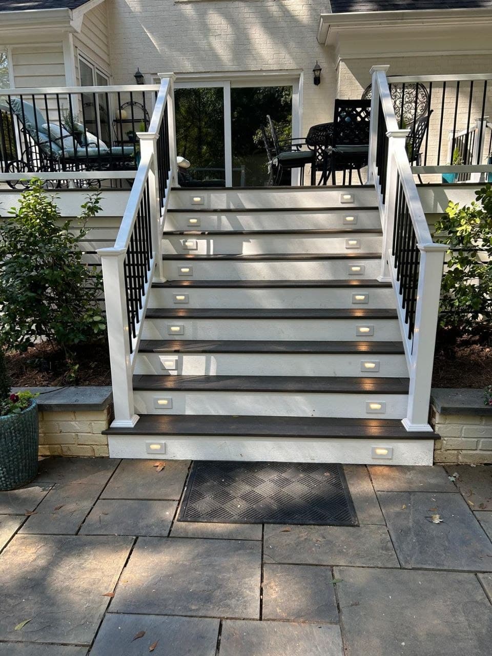 Composite stairs with built-in LED step lighting and white railing